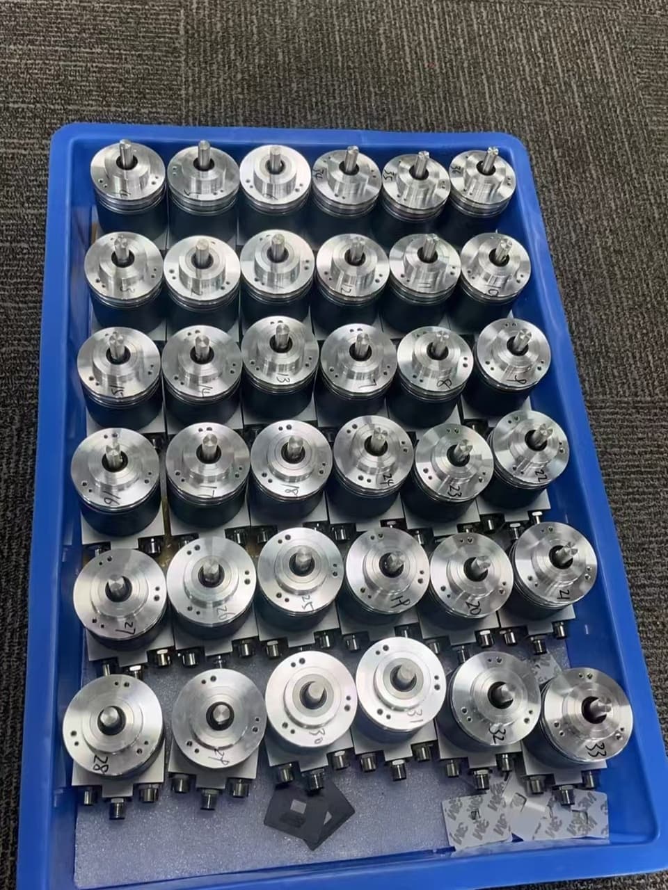 Production batch of encoders in a fixture tray - 100% Factory Tested
